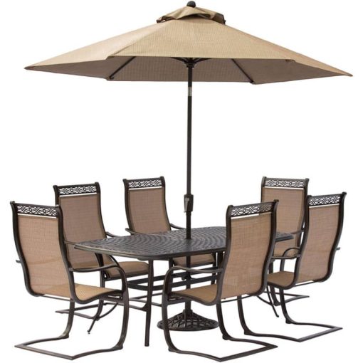 Hanover Manor 7-Piece Outdoor Dining Set In Tan/Bronze With 6 Spring Chairs, 72" x 38" Cast-Top Table, Umbrella, Base